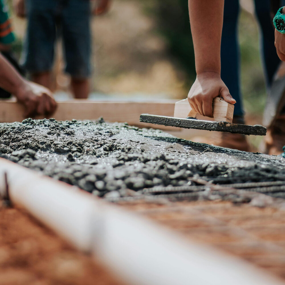 Concrete being applied by hand